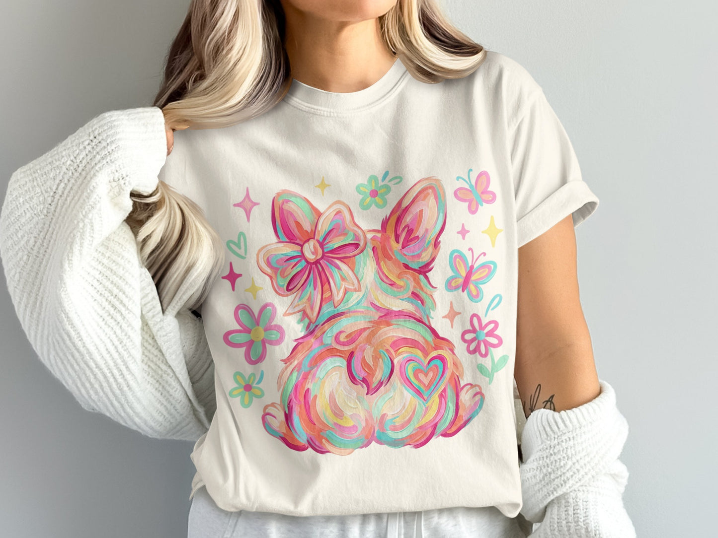 Cream t-shirt with colorful dog butt design, bow, and butterflies.