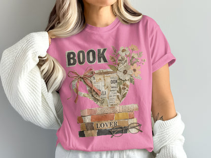 Pink t-shirt with stacked books, teacup, flowers, and "BOOK LOVER" text.