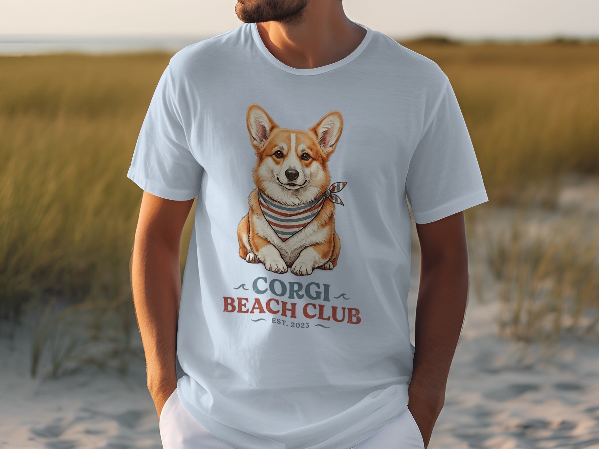 White t-shirt with a cartoon corgi wearing a bandana, "Corgi Beach Club Est. 2023".