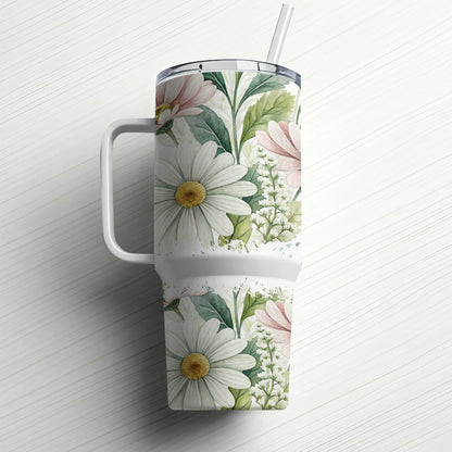 White tumbler with floral pattern and handle, straw inserted.
