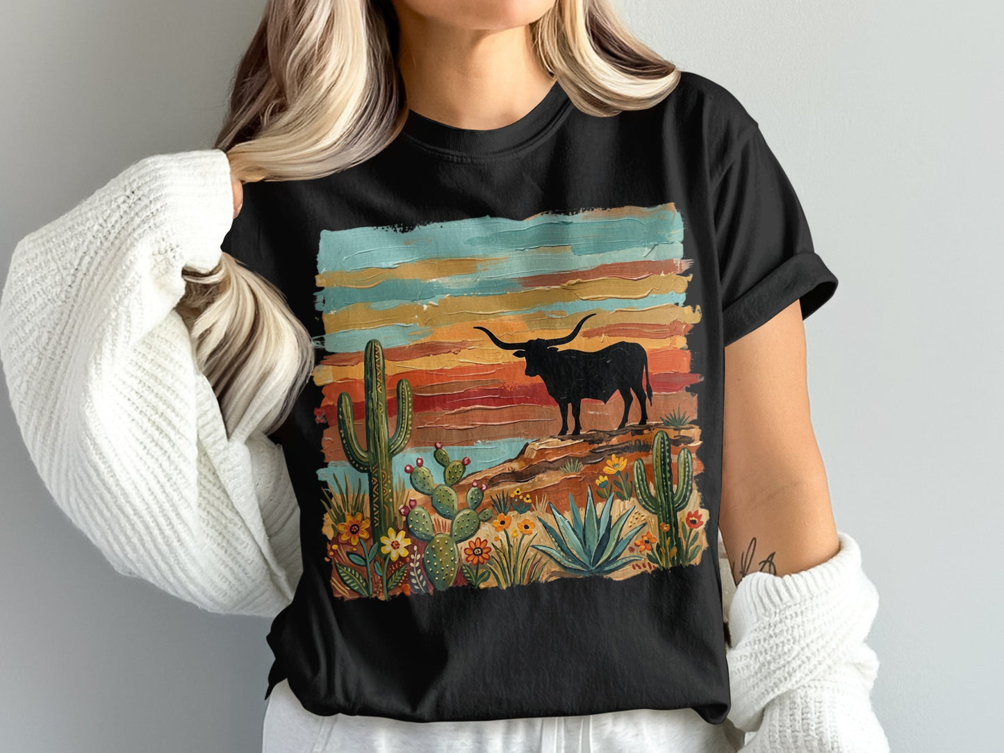 Black t-shirt with desert landscape graphic featuring a longhorn steer and cacti.