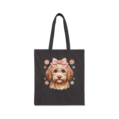 Dark tote bag with a cartoon dog wearing pink glasses and a bow.