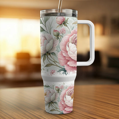Tall tumbler with white handle and pink floral watercolor design.