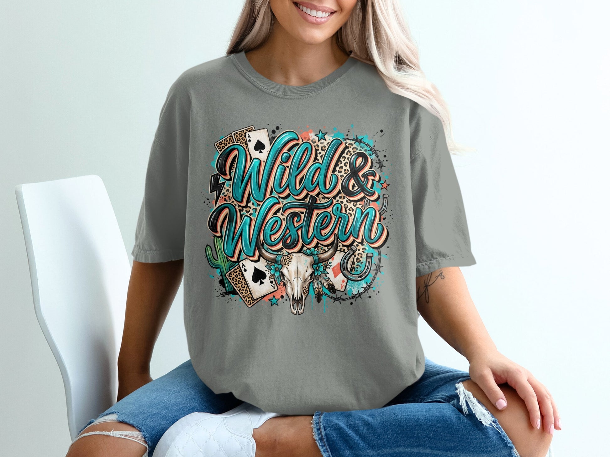 Grey t-shirt with "Wild & Western" text, skull, cards, and cactus design.