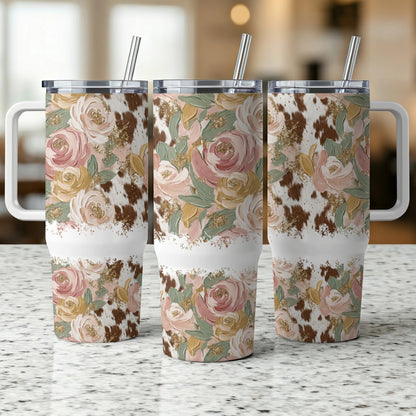 Three tumblers with floral and cowhide patterns sit on a counter.