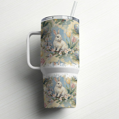 White tumbler with a floral and bunny design, and a straw.