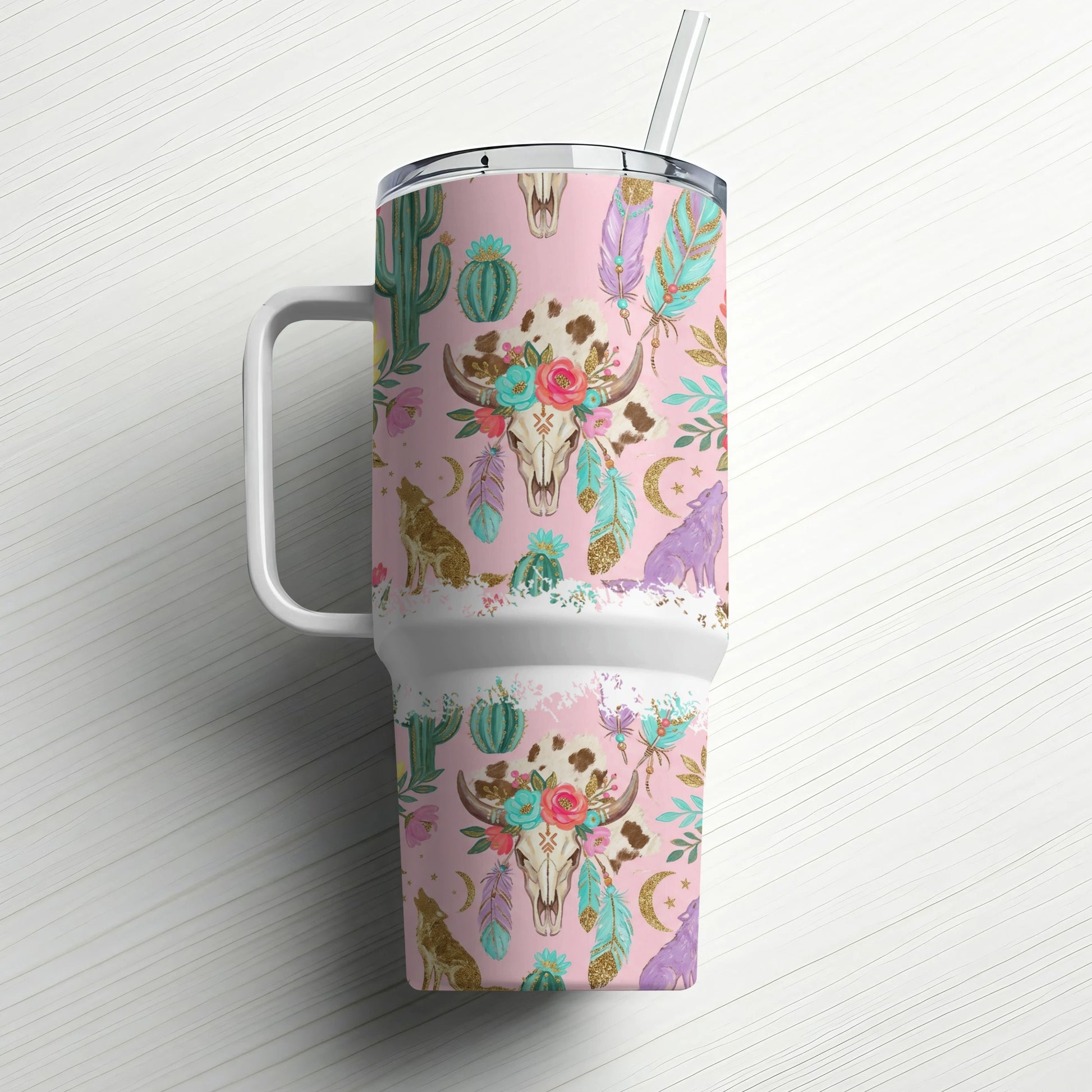 Pink tumbler with skull, wolf, cactus, and feather pattern.