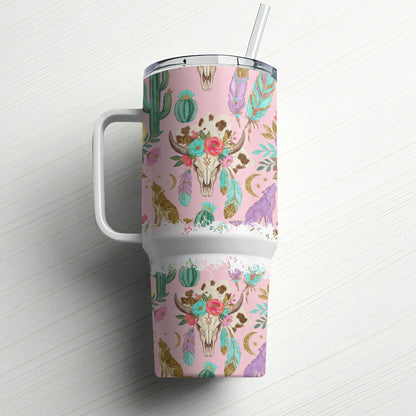 Pink tumbler with skull, wolf, cactus, and feather pattern.