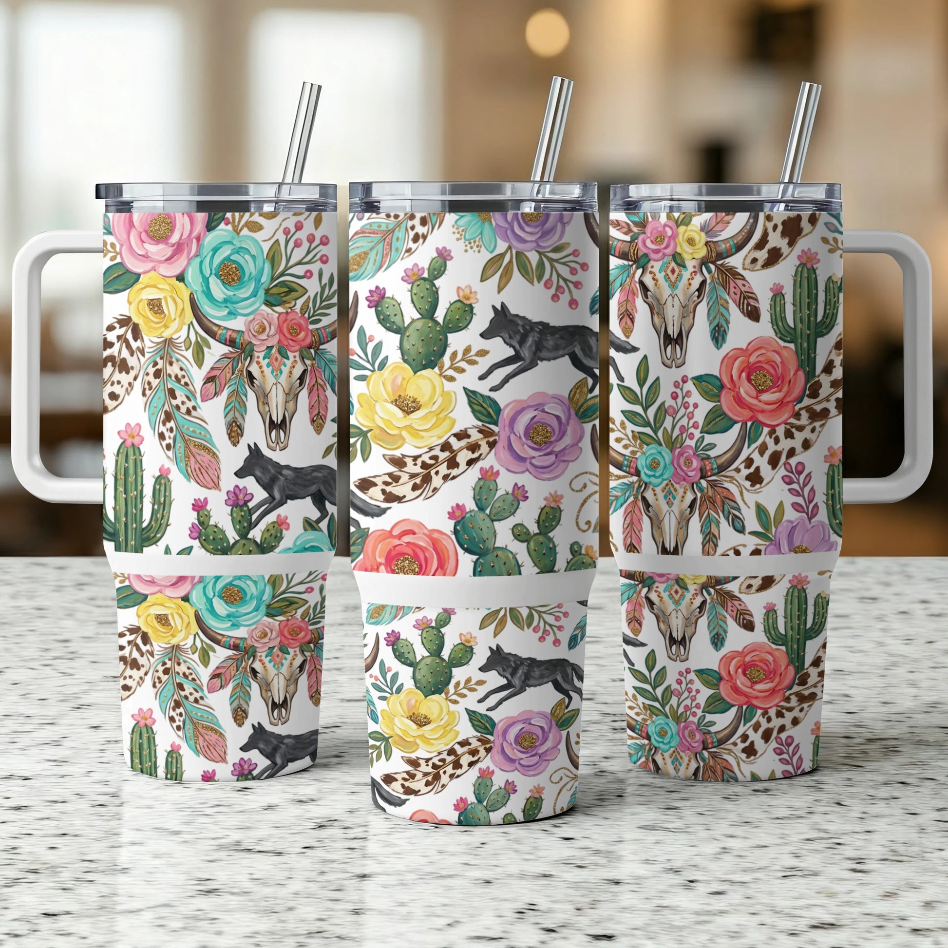Three tumblers with floral, cactus, feather, and wolf skull designs.