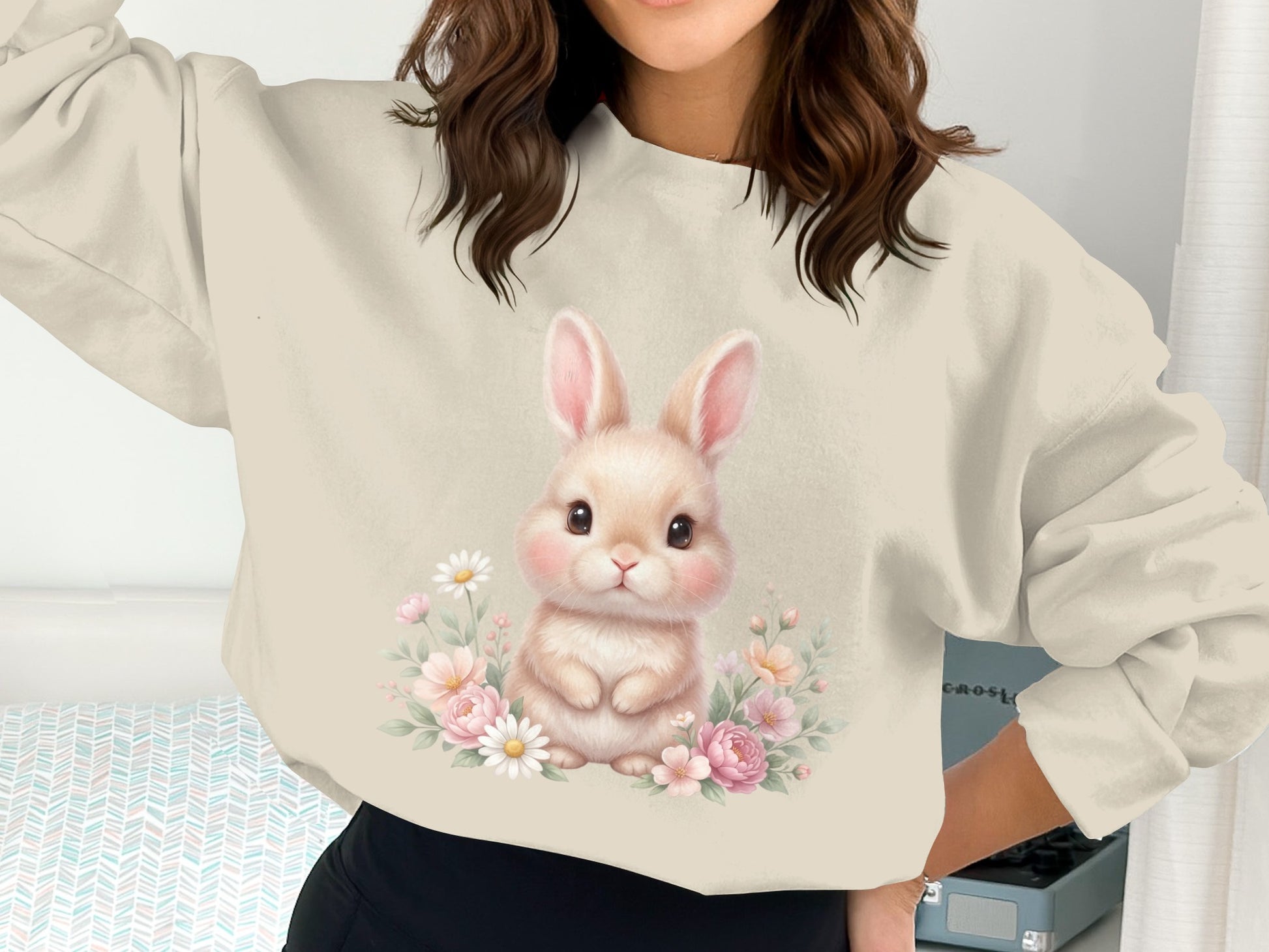 Cream sweatshirt with a cute cartoon bunny surrounded by flowers.