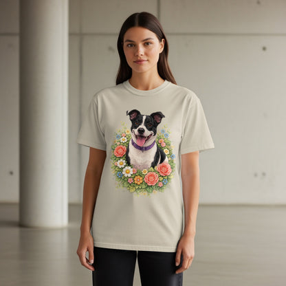Woman wearing a tan t-shirt with a floral dog portrait design.