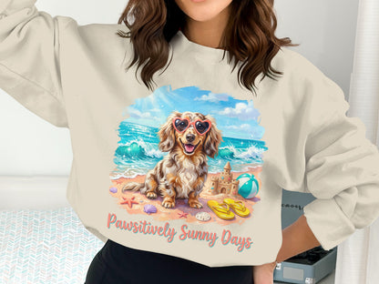Dachshund in heart sunglasses on beach with sandcastle and text "Pawsitively Sunny Days".