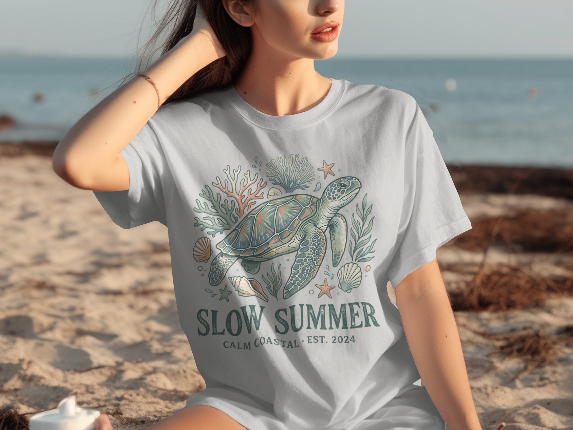 T-shirt with a sea turtle, coral, and shells design.