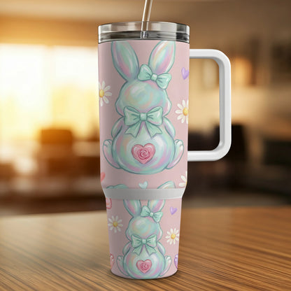 Pastel bunny with bows and daisies on a tumbler with handle.