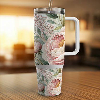 White tumbler with a floral pattern of pink peonies and greenery.