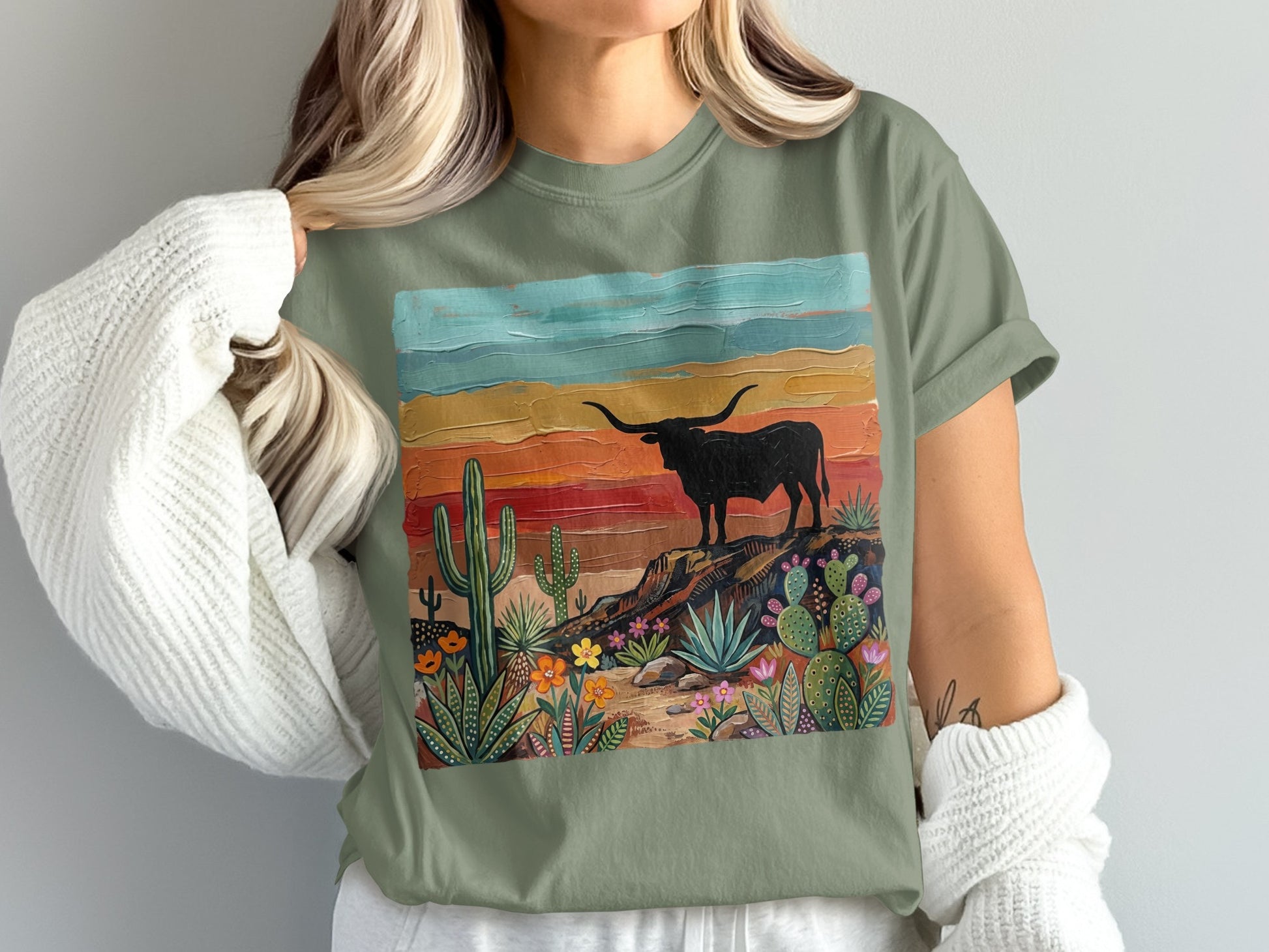 T-shirt featuring a stylized desert landscape with a longhorn silhouette.