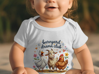 Baby wearing white bodysuit with "Barnyard Drama Club" and cartoon animals.
