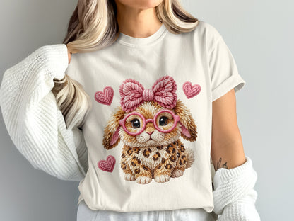 White t-shirt with a fluffy bunny graphic wearing pink glasses and a pink bow.
