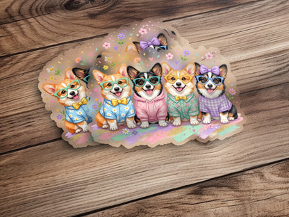 Five cartoon corgis wearing glasses and colorful hoodies smile.