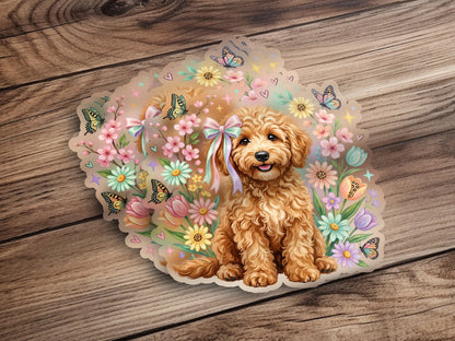 Fluffy golden doodle puppy surrounded by pastel flowers and butterflies.