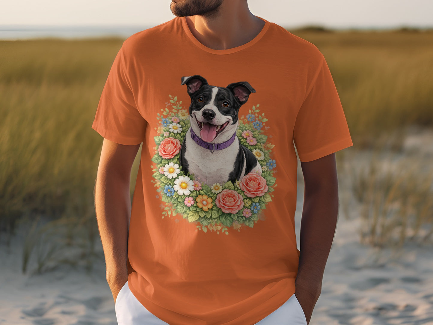 Orange t-shirt featuring a black and white dog in a floral wreath.