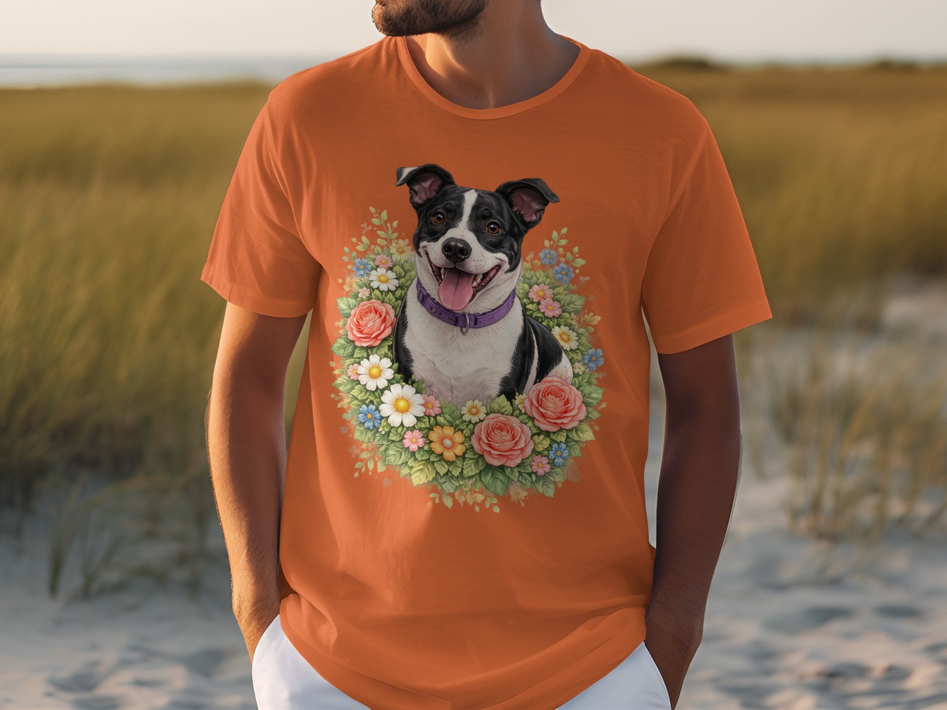 Orange t-shirt featuring a black and white dog in a floral wreath.