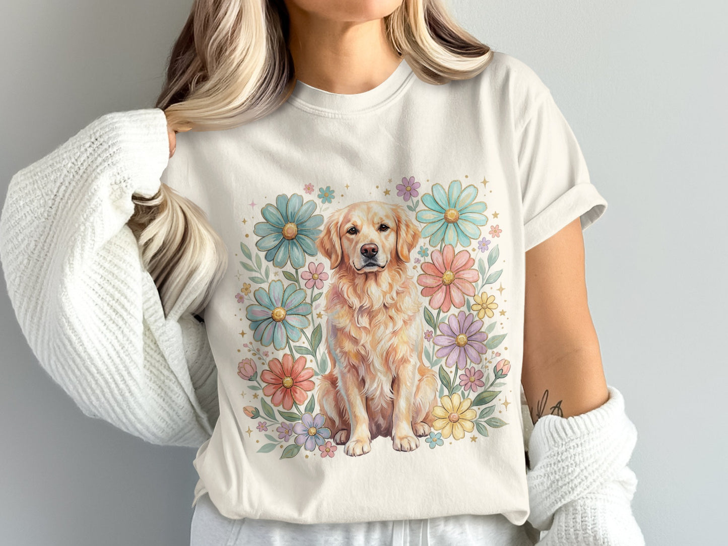 Golden Retriever dog sitting among pastel flowers on a cream t-shirt.