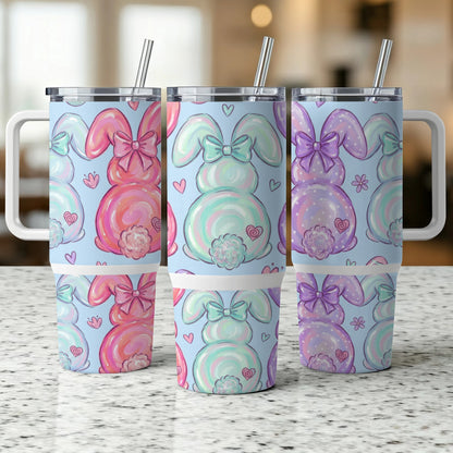 Three pastel bunny tumblers with heart and flower patterns.