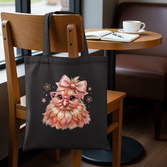 Black tote bag with a cartoon fluffy chick wearing pink glasses and a bow.