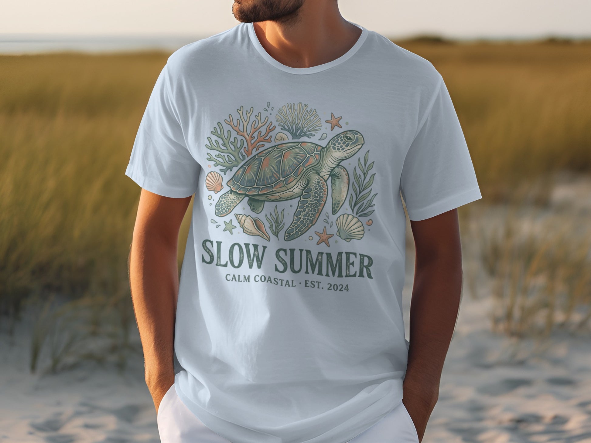 White t-shirt with a sea turtle, coral, and shells graphic and "SLOW SUMMER" text.