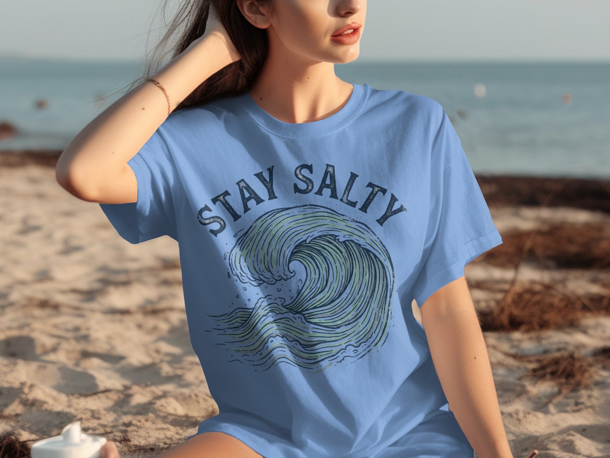 Blue t-shirt with "STAY SALTY" text and a stylized ocean wave design.