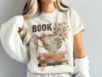 T-shirt graphic with the word "BOOK" and a teacup filled with flowers over stacked books.
