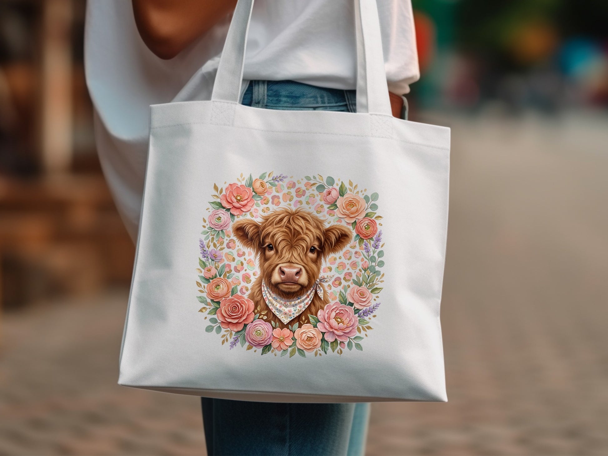 White tote bag with Highland cow surrounded by a floral wreath.