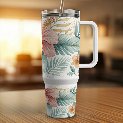 White tumbler with tropical flowers and leaves, featuring a handle.