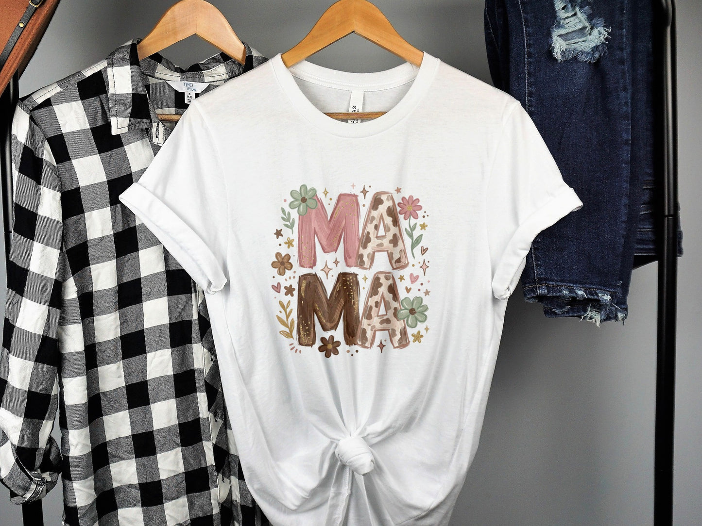 White t-shirt with floral "MAMA" text and decorative flowers.