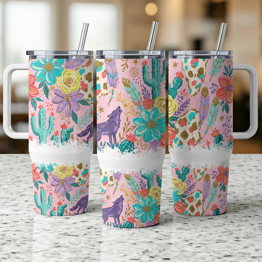 Three pink tumblers with floral and cactus desert pattern, one with wolf silhouette.