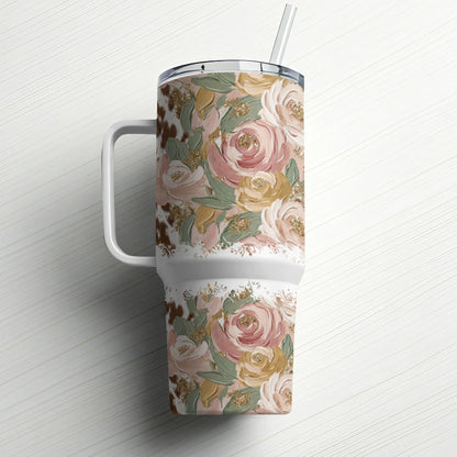 Floral patterned tumbler with straw on a white wood background.