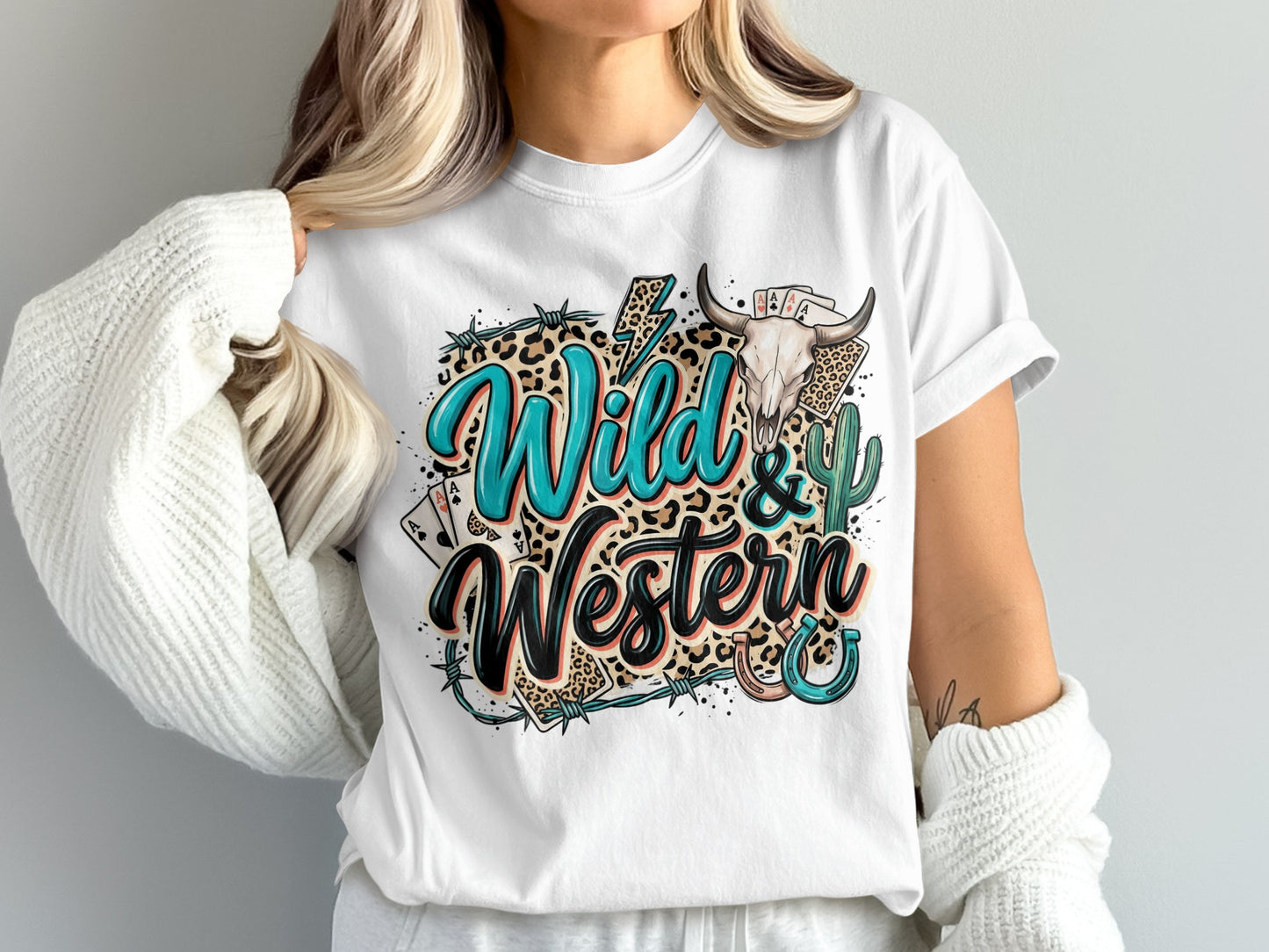 Wild & Western text with skull, cards, and cactus graphic on a white t-shirt.