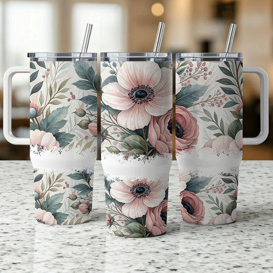 Three floral patterned tumblers with straws on a speckled countertop.