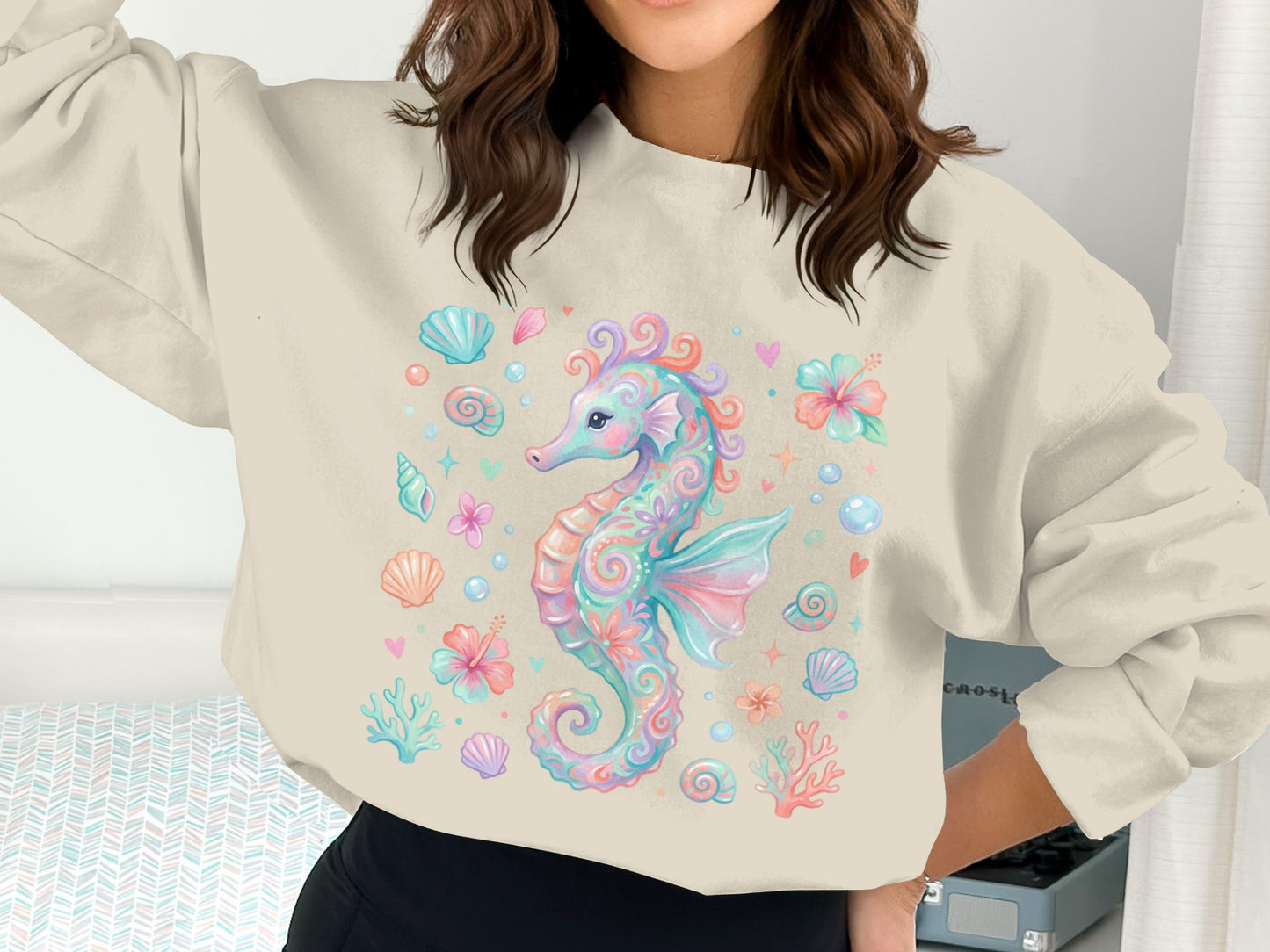 Seahorse and seashells graphic on a cream crewneck sweatshirt.