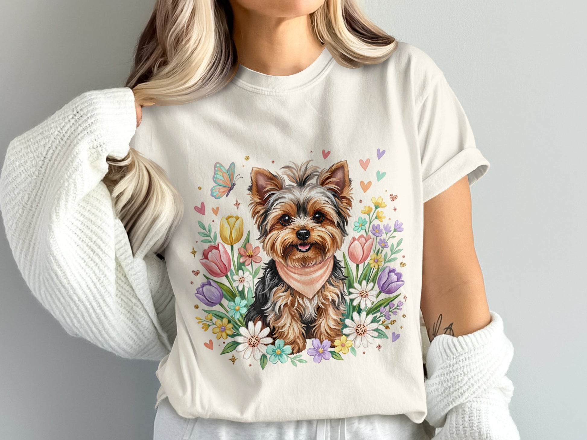 Yorkshire terrier wearing a bandana surrounded by colorful flowers and butterflies.