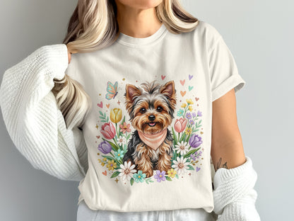 Yorkshire terrier wearing a bandana surrounded by colorful flowers and butterflies.