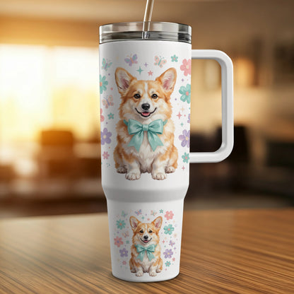 Corgo with teal bow on white tumbler with floral and butterfly designs.
