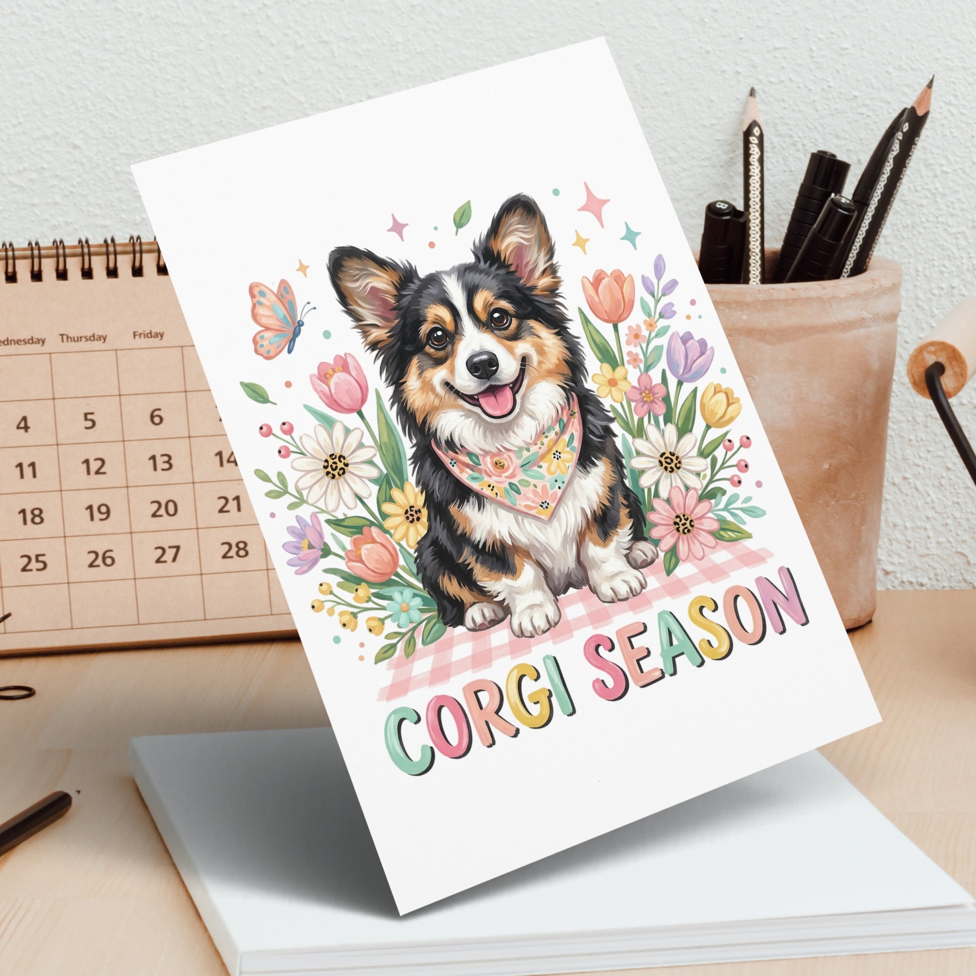A smiling corgi wears a bandana surrounded by flowers, with "CORGI SEASON" text.