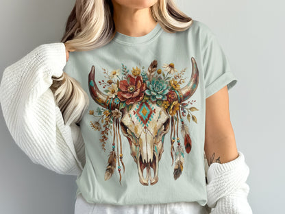 Skull with floral and feather headdress on light blue t-shirt.