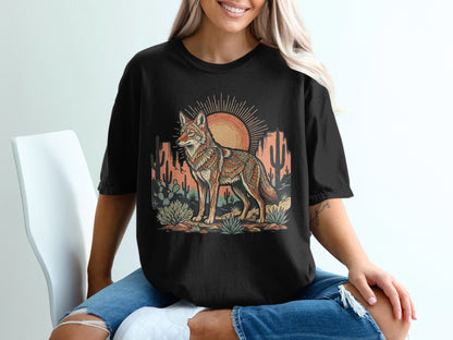 T-shirt graphic featuring a desert scene with a stylized coyote and sun.