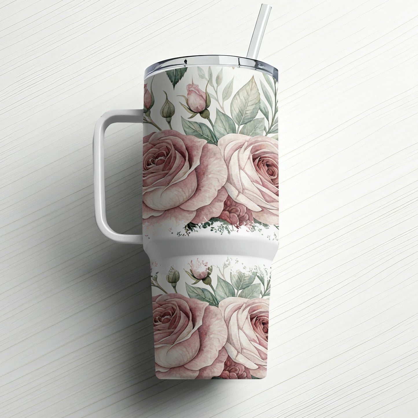 White tumbler with pink roses and green leaves, straw in lid.
