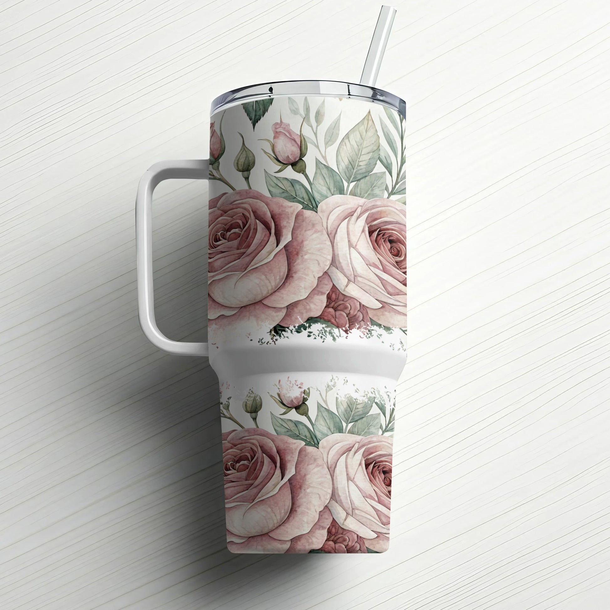 White tumbler with pink roses and green leaves, straw in lid.