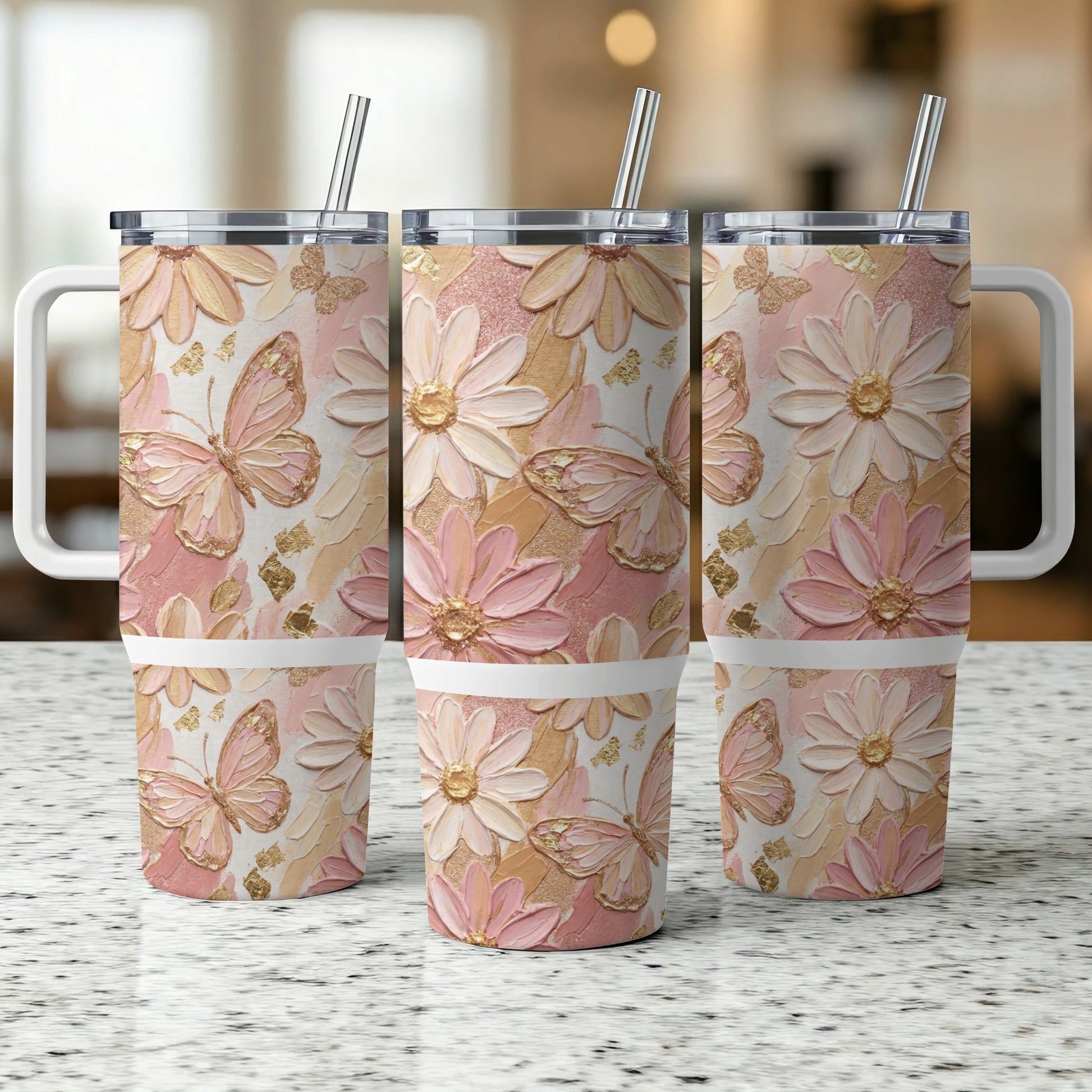 Three tumblers with a pink, gold, and white floral and butterfly design.