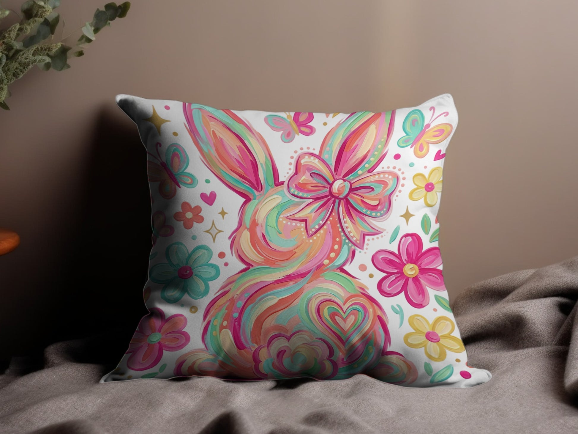 Colorful painted bunny with bow, butterflies, and flowers on a pillow.